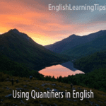A sunset over a mountain lake with the overlay text "Using Quantifiers in English" and the EnglishLearningTips.com logo.