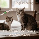 Cats sitting on a wooden table illustrating the preposition of place "on".