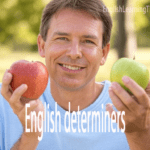 Man holding two different apples to demonstrate determiners