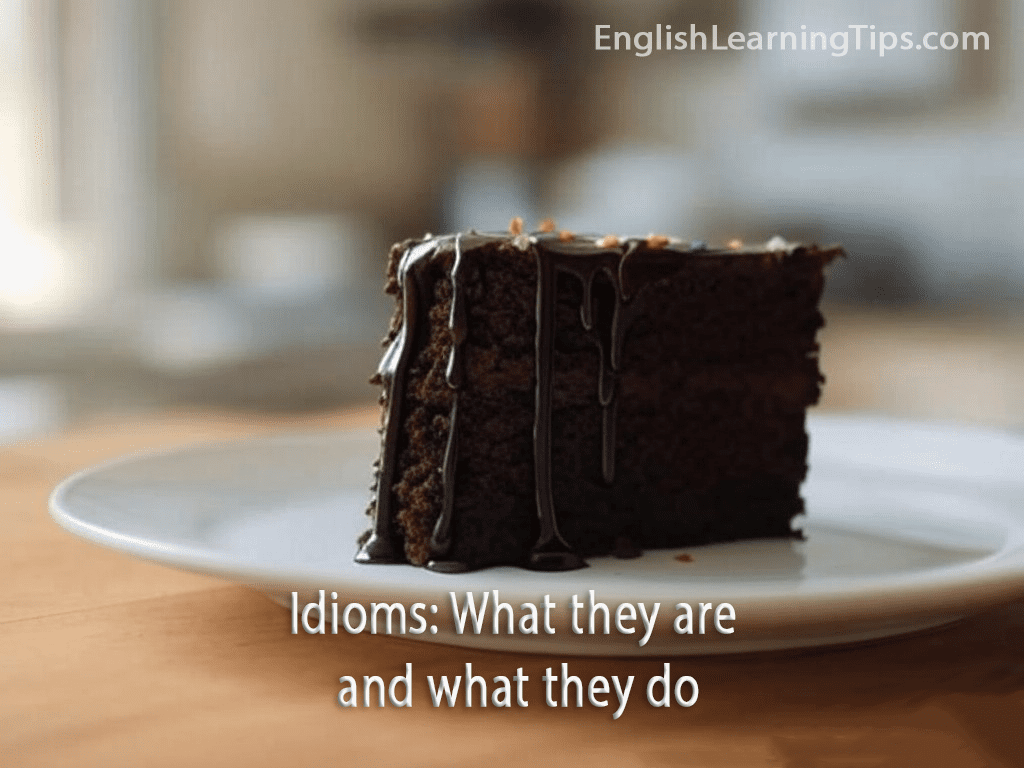 A slice of chocolate cake on a white plate representing the English idiom "a piece of cake"