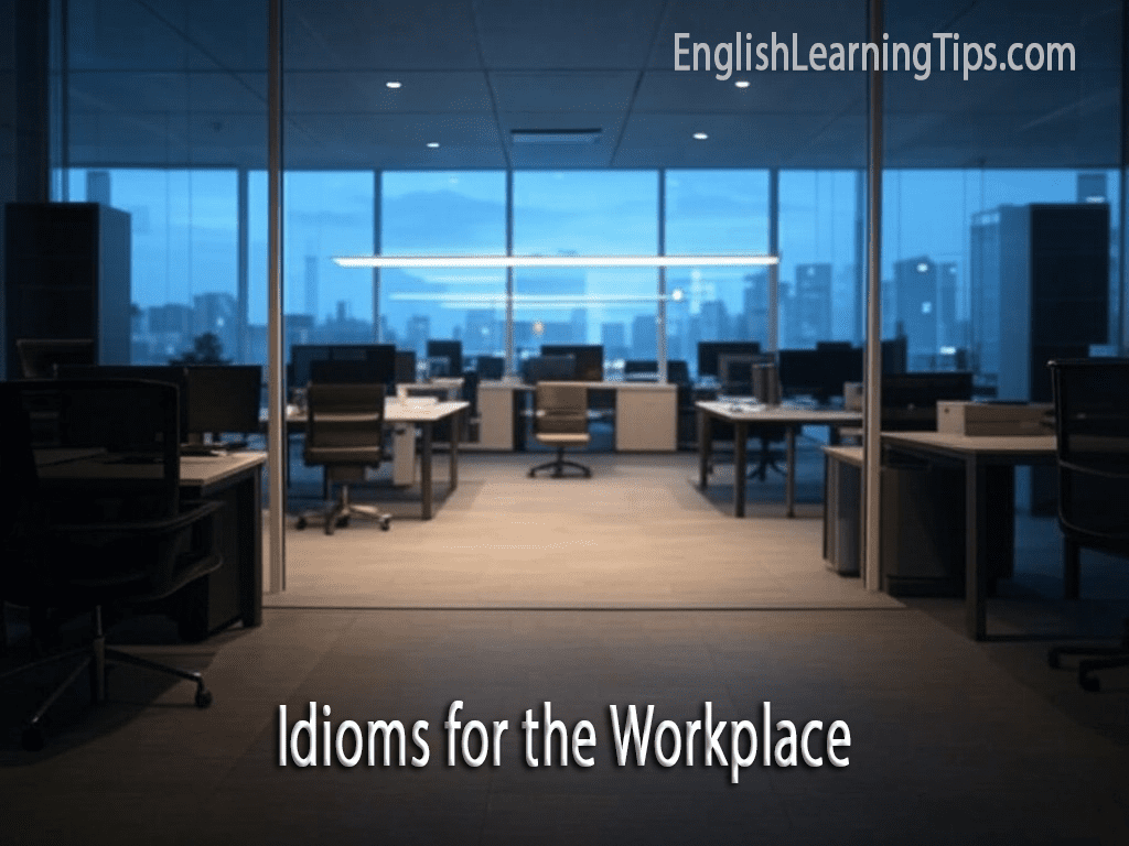 An empty modern office at night with city lights in the background and text overlaying that says "Idioms for the Workplace" and the website "EnglishLearningTips.com."