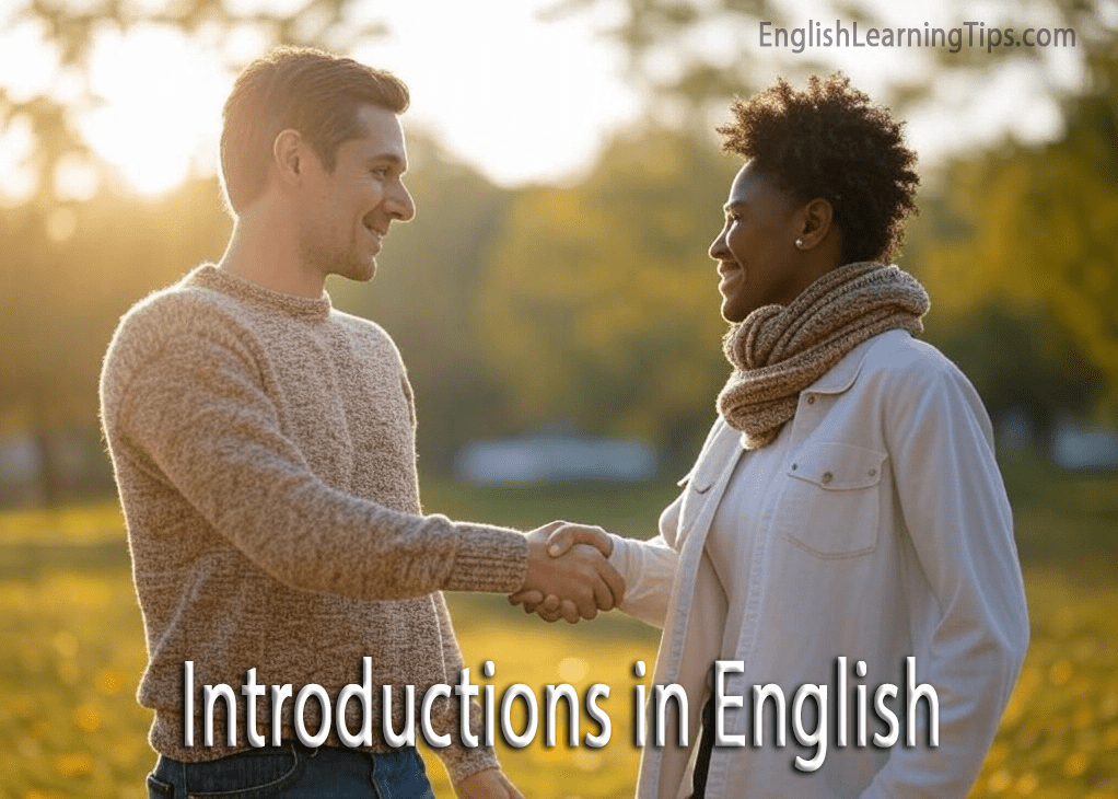 A man and a woman smiling and shaking hands during an introduction in a park setting.