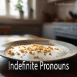 A plate with crumbs on a kitchen table used as a visual metaphor for indefinite pronouns like "something" or "anything."