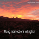A desert landscape at sunset with the text Using Interjections in English overlaid, serving as a featured image for a grammar guide.