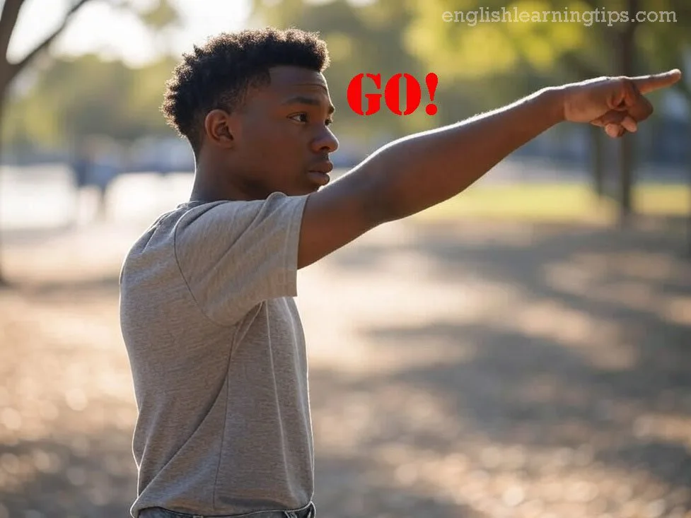 A young man pointing away from himself with the word "GO!" in red text, illustrating movement away from a speaker.