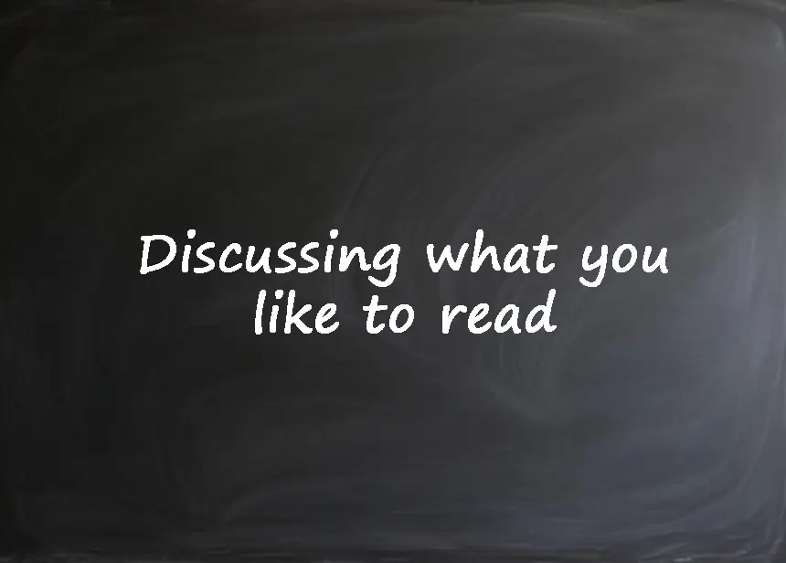 A chalkboard with the text "Discussing what you like to read" written on it for an English language lesson.