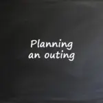 ext written on a chalkboard that says Planning an outing, representing an ESL classroom activity.