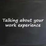 A blackboard with the text "Talking about your work experience" written in white chalk.