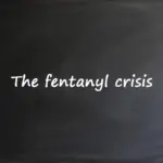 Blackboard with text reading The fentanyl crisis, representing an educational lesson on opioid awareness.